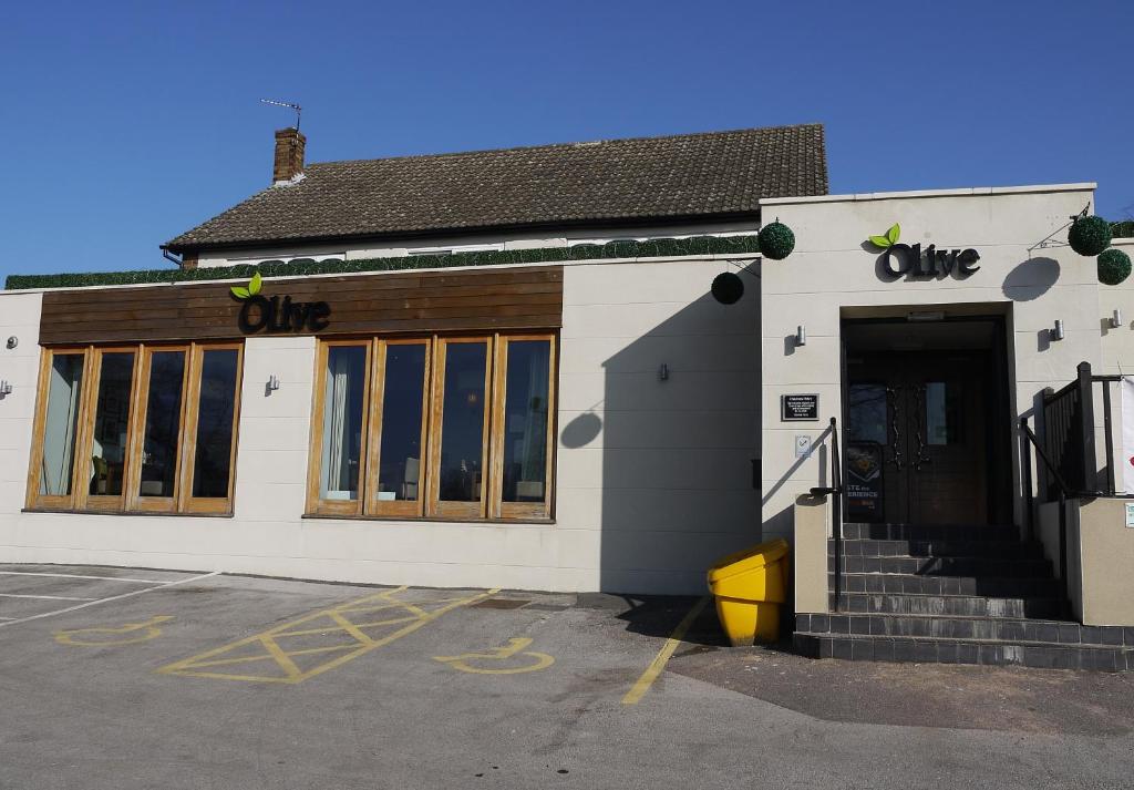 a store with a one sign on the front of it at The Lodge in Barnby Dun