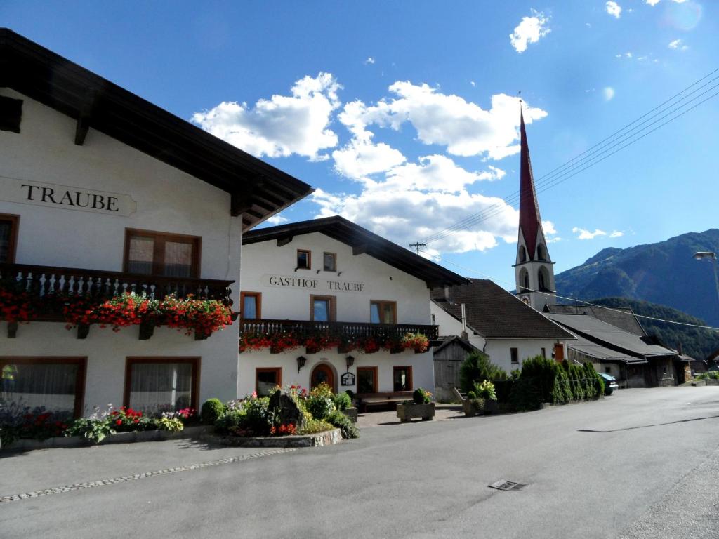 a building with a church with a steeple at Gasthof Pension Traube in Karres