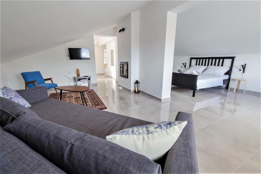 a living room with a couch and a bed at Apartments Dolores in Senj