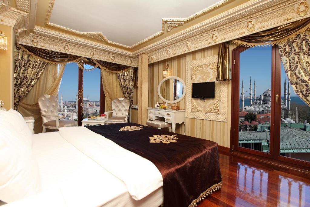 a hotel room with a large bed and a large window at Deluxe Golden Horn Sultanahmet Hotel in Istanbul