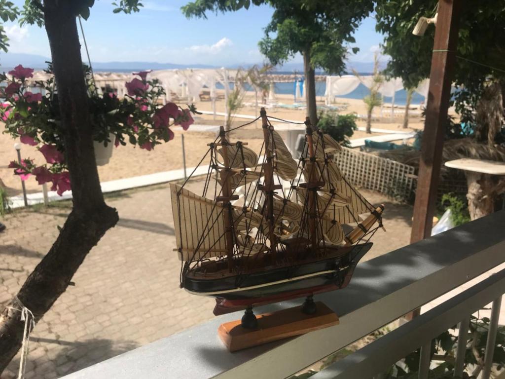 a model ship sitting on top of a bench at Studios on the Beach in Skala Sotiros