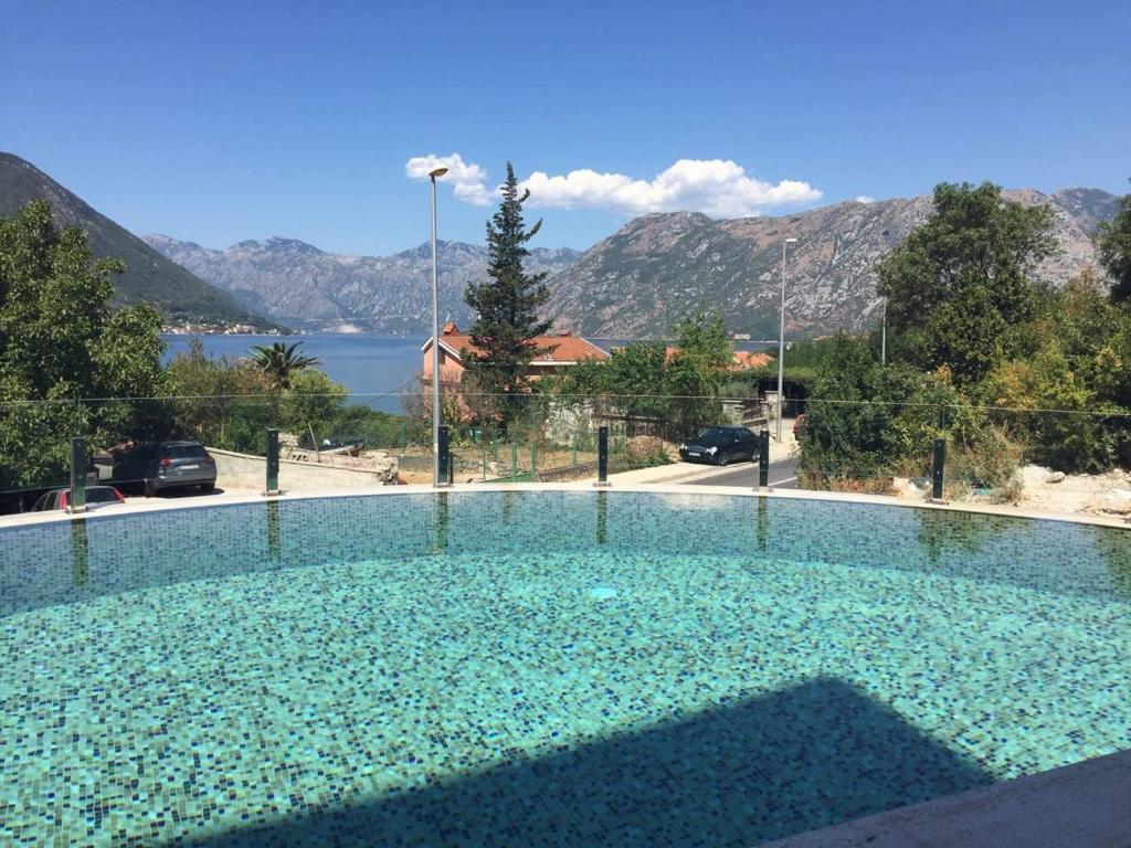 a large swimming pool with a view of the water at Minka in Kotor