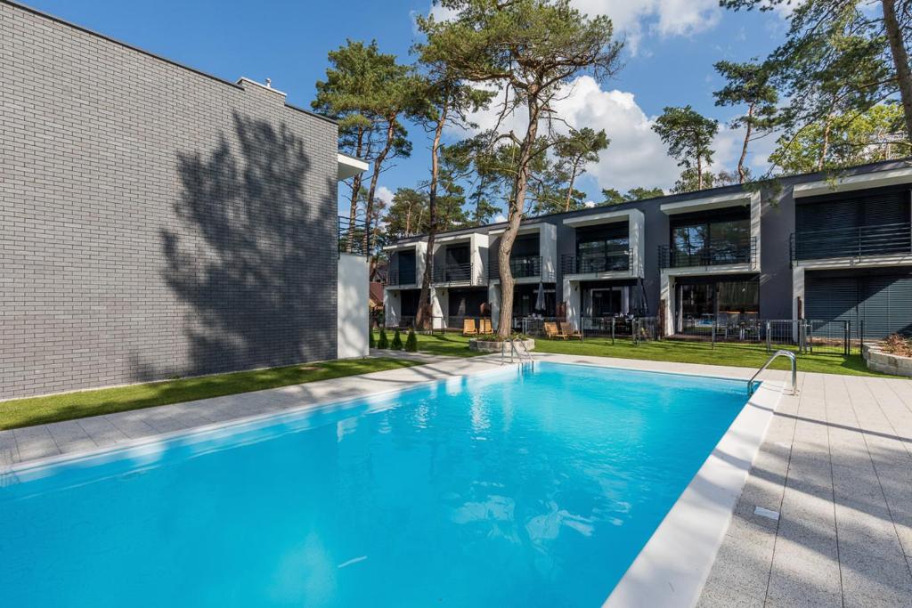 a swimming pool in front of a building at One & Only in Pobierowo