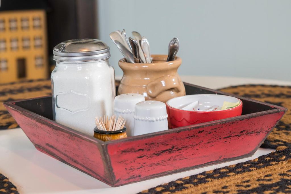 a tray with utensils and other items on a table at Mama`s By The Sea B&B in Clark's Harbour