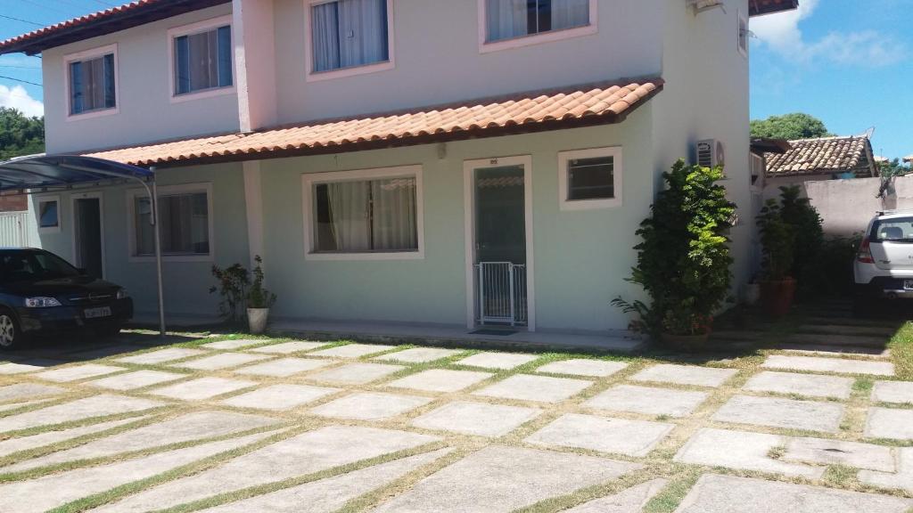 a house with a car parked in front of it at Guest House Paraiso Pataxos in Porto Seguro