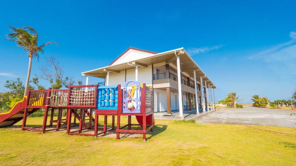 a playground in front of a house at Coconutpalm Home in Hengchun South Gate