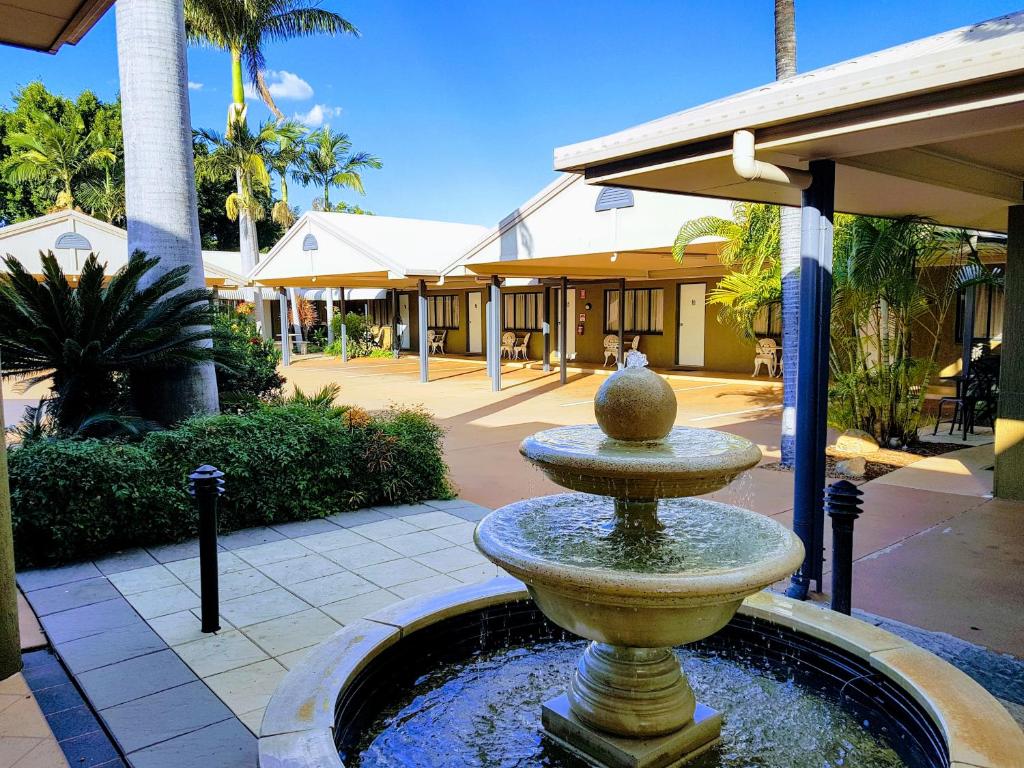 
a water fountain in front of a building at Rockhampton Palms Motor Inn in Rockhampton
