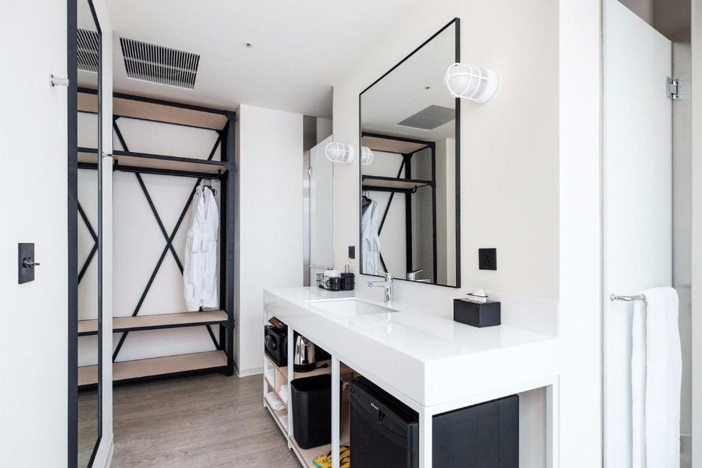 a bathroom with a sink and a mirror at amba Taipei Songshan in Taipei