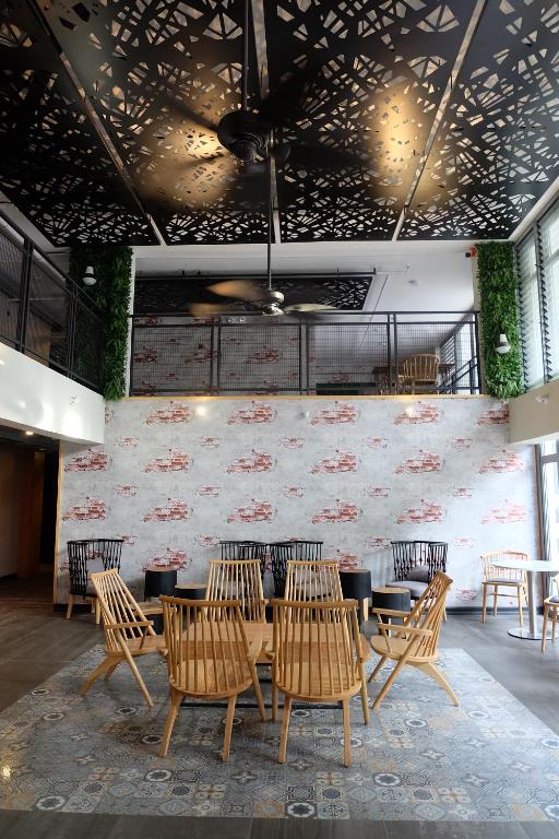 a restaurant with a table and chairs in a room at Cuna Hotel in El Nido