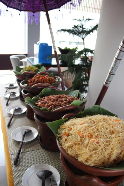 a group of bowls of food on a table at Kyriad Hotel Airport Jakarta in Tangerang