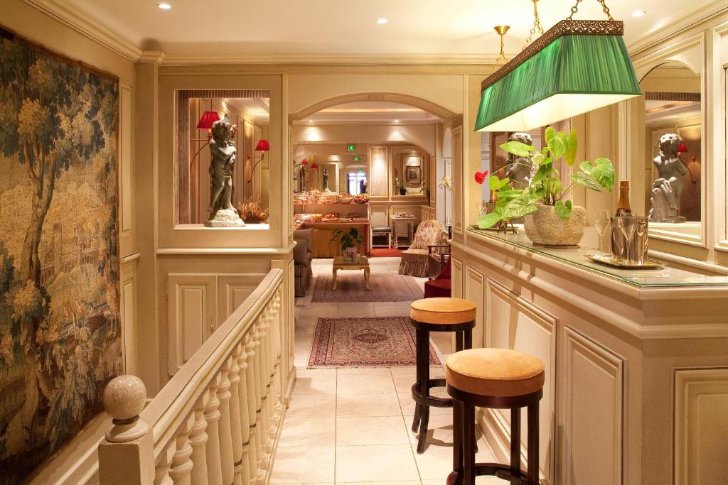 a hallway with a bar with stools in a house at Au Manoir Saint Germain in Paris