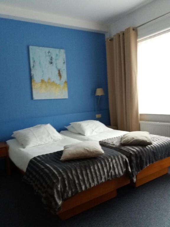 Postel nebo postele na pokoji v ubytování Hotel 'T Hert