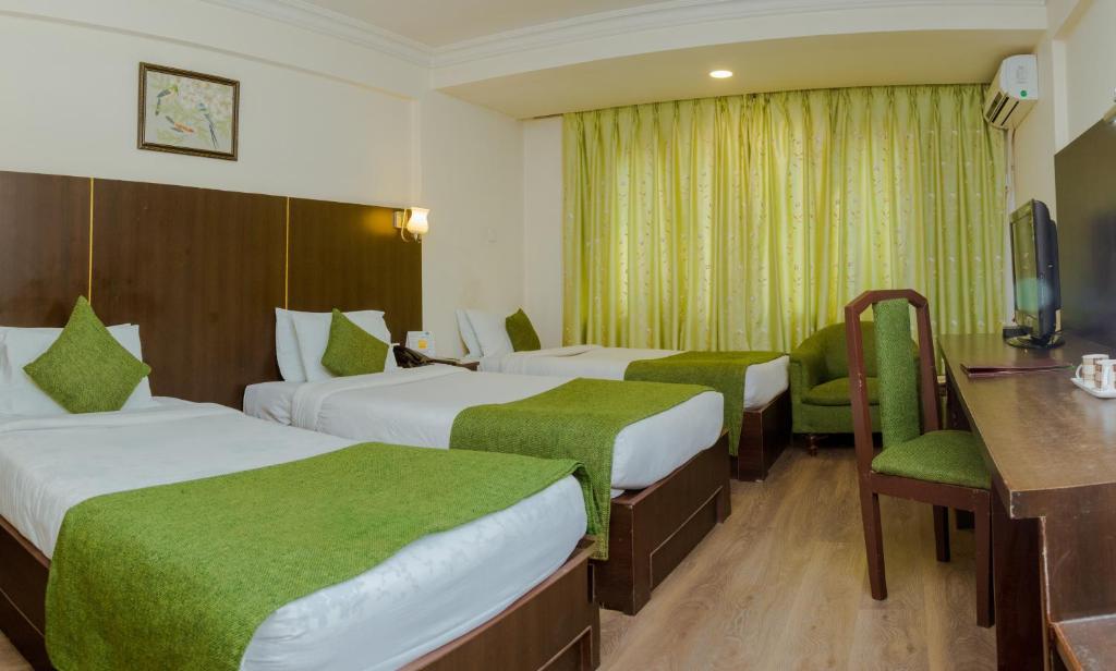 Postel nebo postele na pokoji v ubytování Hotel Vaishali