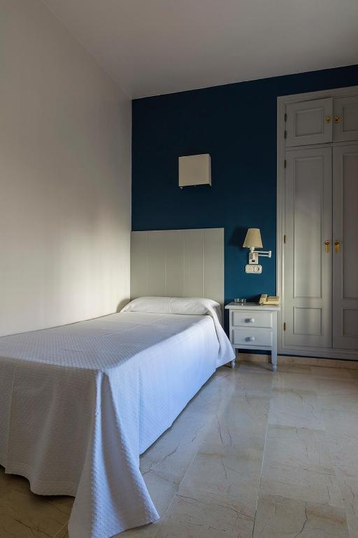 Postel nebo postele na pokoji v ubytování Hostal Drago