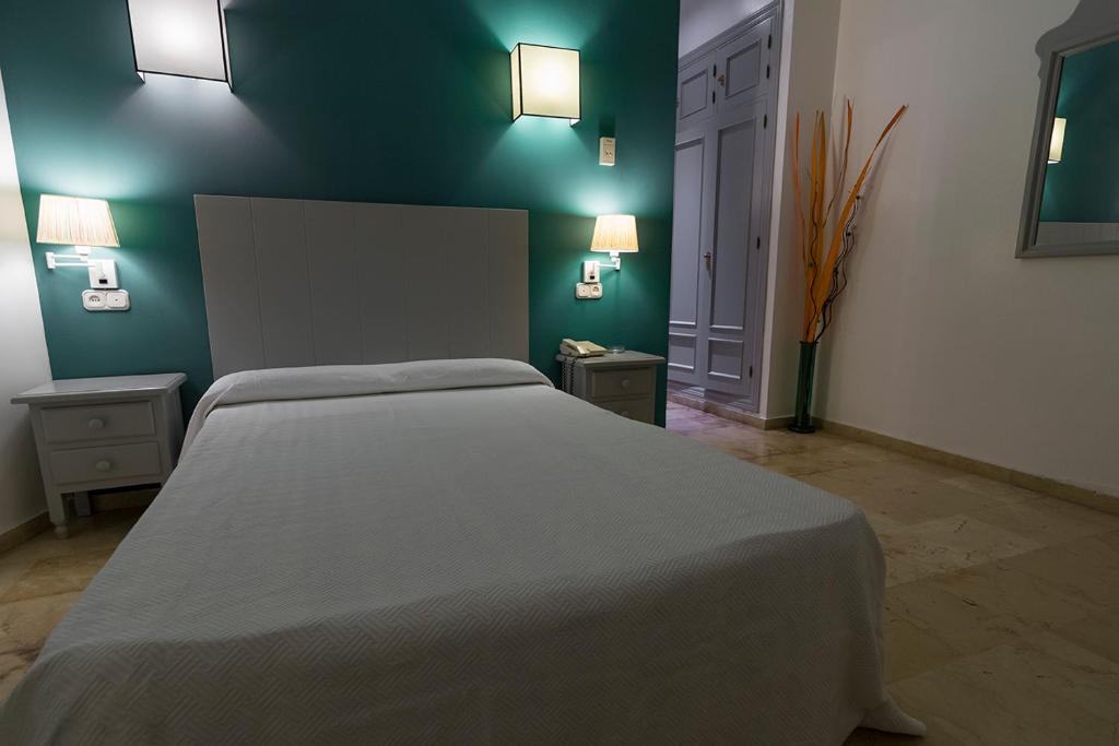 Postel nebo postele na pokoji v ubytování Hostal Drago