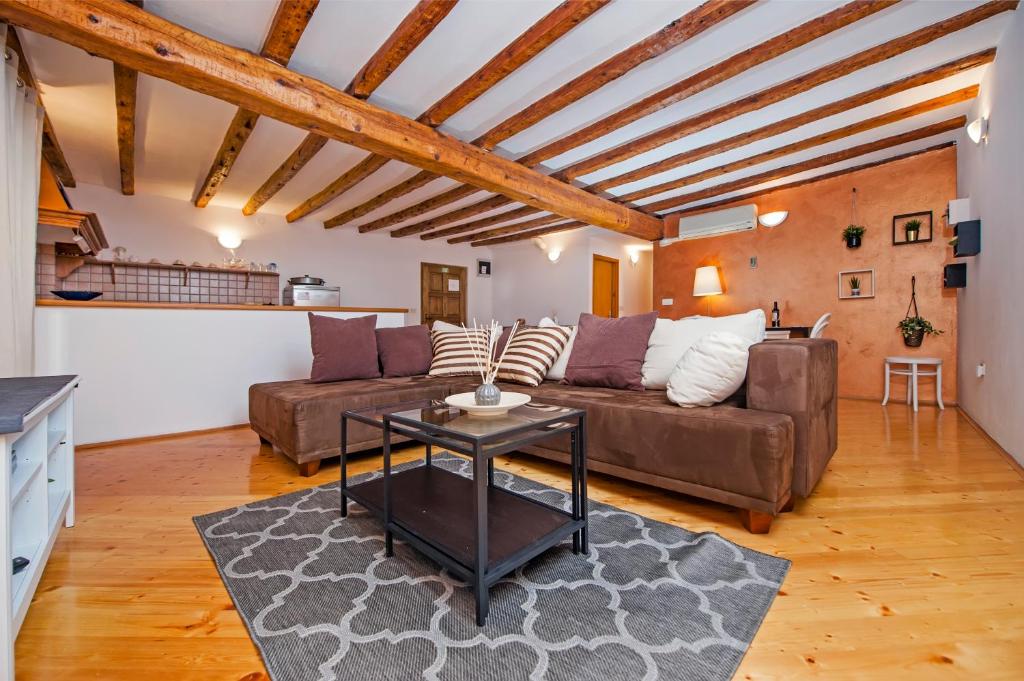 a living room with a couch and a table at Apartment Marconi in Rovinj