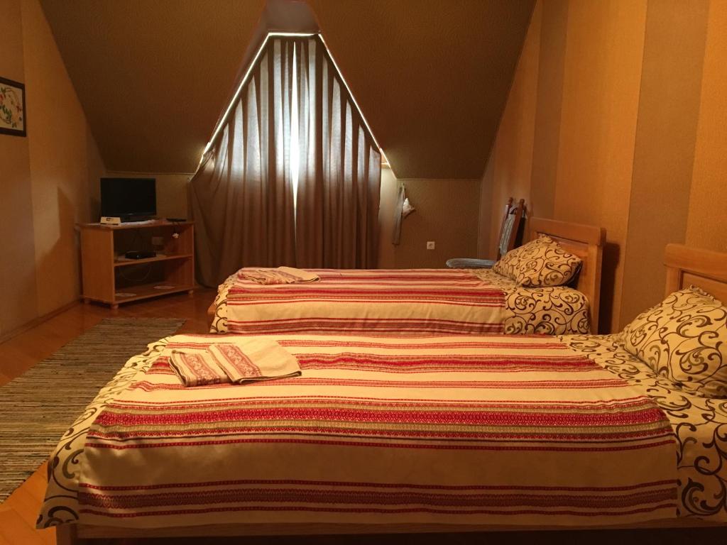 Postel nebo postele na pokoji v ubytování Hotel Svitlytsia