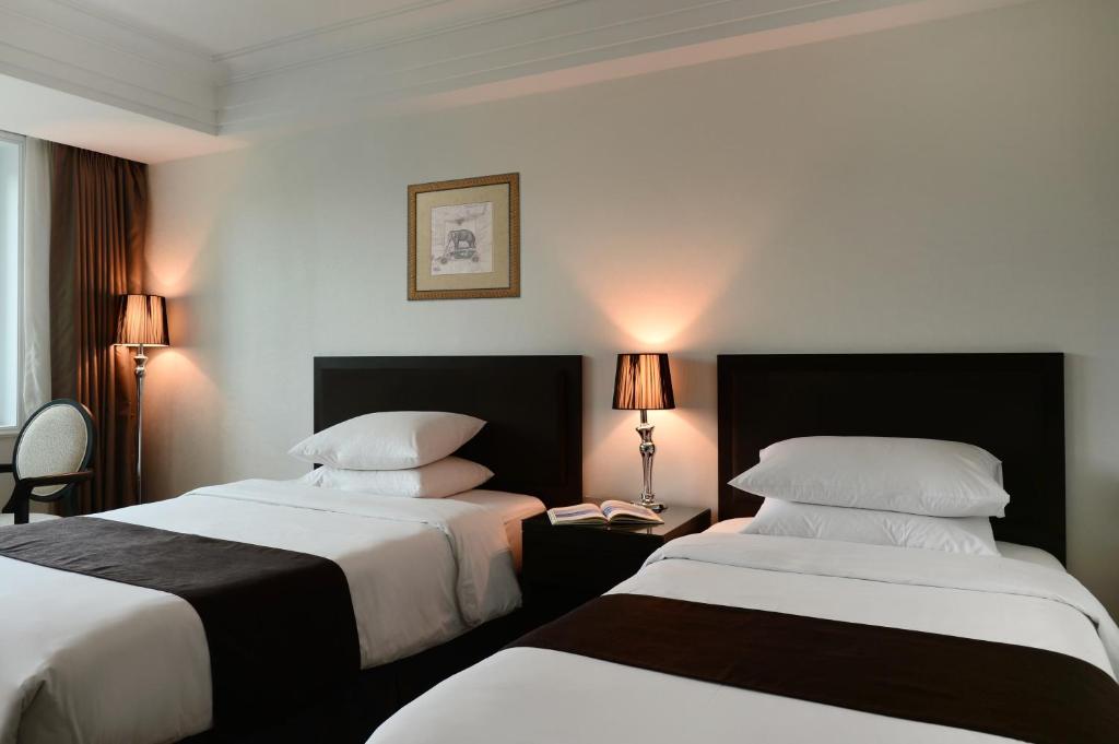Postel nebo postele na pokoji v ubytování Jeju Oriental Hotel & Casino