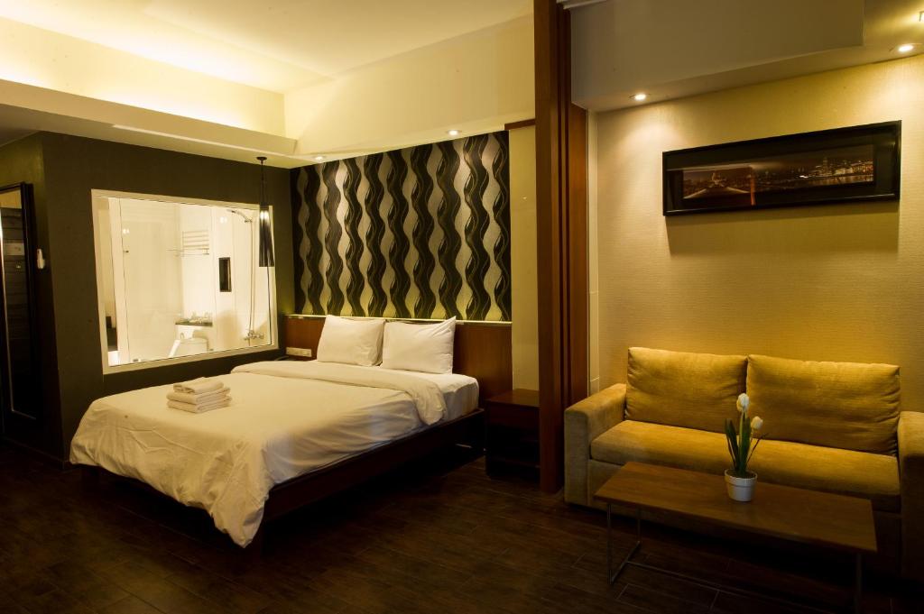 Postel nebo postele na pokoji v ubytování Inn Residence Serviced Suites - SHA Extra Plus