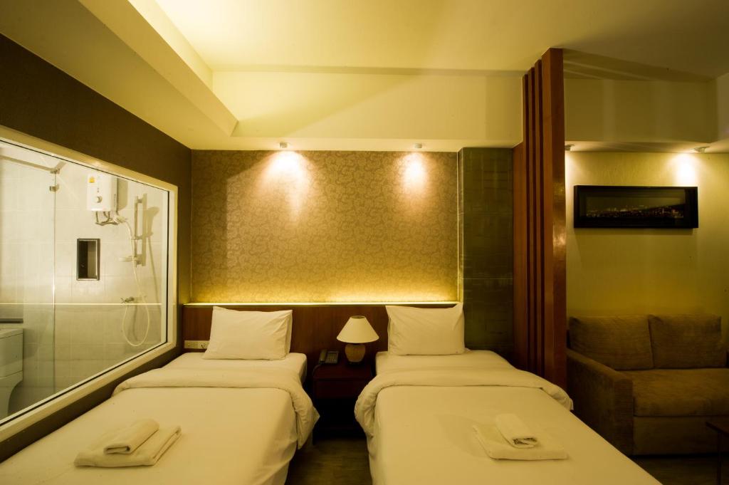 Postel nebo postele na pokoji v ubytování Inn Residence Serviced Suites - SHA Extra Plus