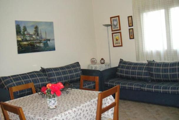 a living room with a couch and a table with flowers on it at Lovely house with garden at an excellent location! in Agria