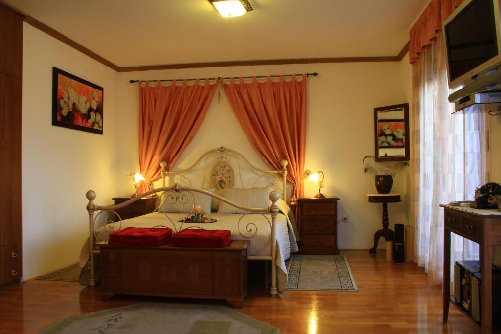 a bedroom with a bed with red pillows on it at Apartments Znjan in Split