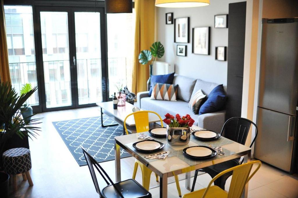 a living room with a table and chairs at 3D Szlak 77 Apartament in Kraków