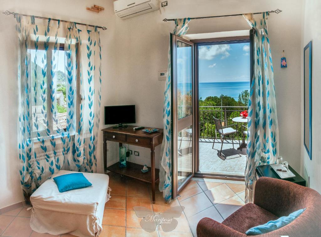 a living room with a view of the ocean at B&B Mariposa in Maratea