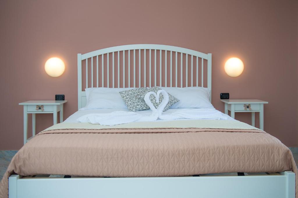 a white bed with two end tables in a bedroom at Hotel San Giovanni in Polignano a Mare