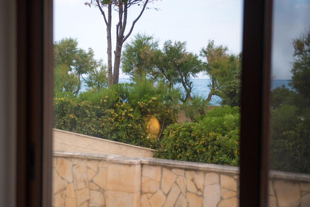 a view from a window of a garden at Hotel San Giovanni in Polignano a Mare
