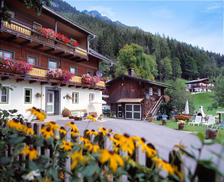 a building with a bunch of sunflowers in front of it at Kalcherhof in Ramsau am Dachstein