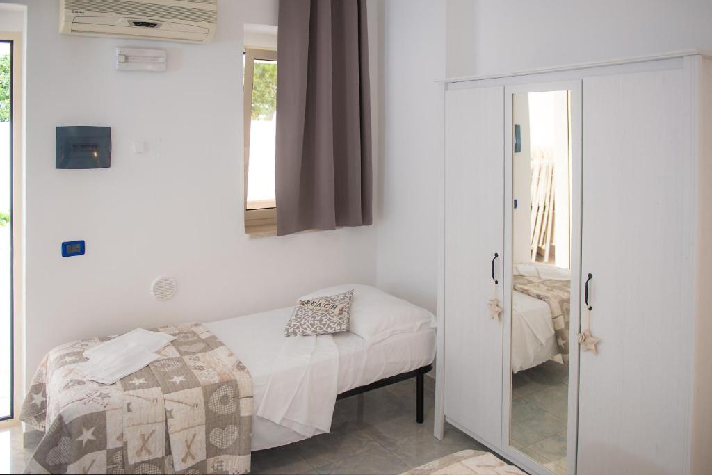 a bedroom with a bed and a mirror at Hotel San Giovanni in Polignano a Mare