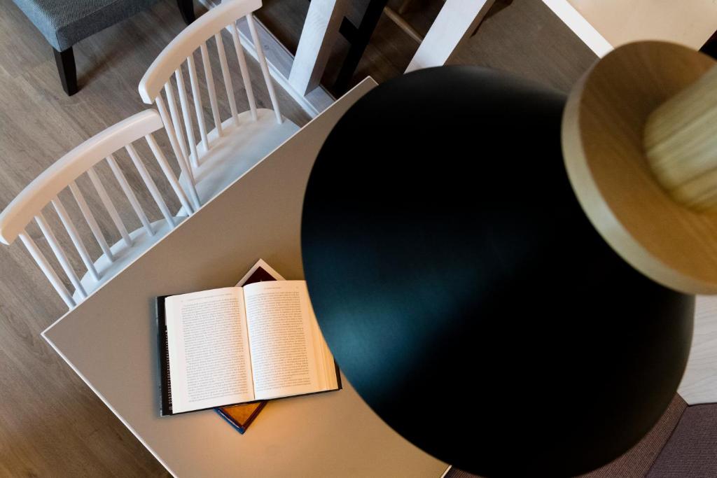 a table with a book and a hat on it at Albergue Goas in Abadín