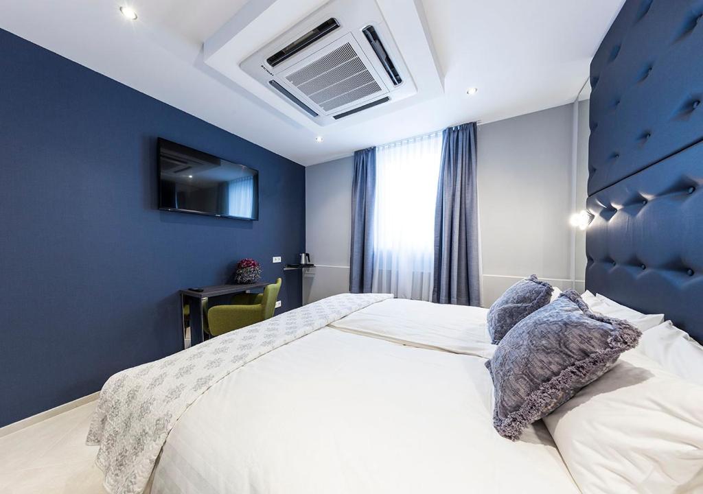 Postel nebo postele na pokoji v ubytování Hotel Tommasi
