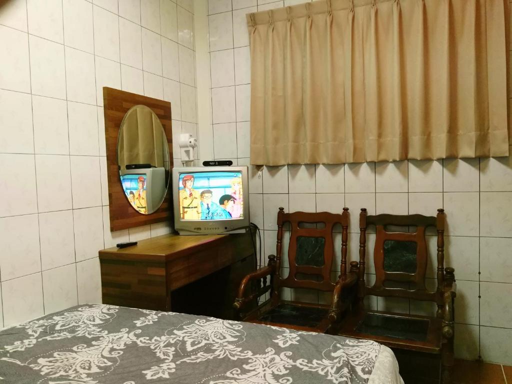 Postel nebo postele na pokoji v ubytování Qun Feng Hotel