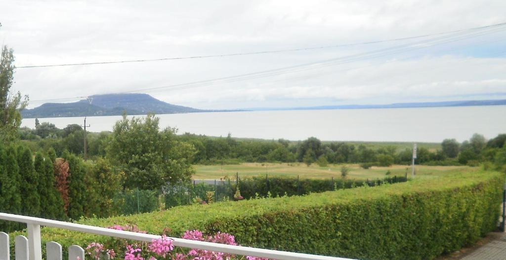 a view of the water from the balcony of a house at Holdfény Apartman in Balatongyörök