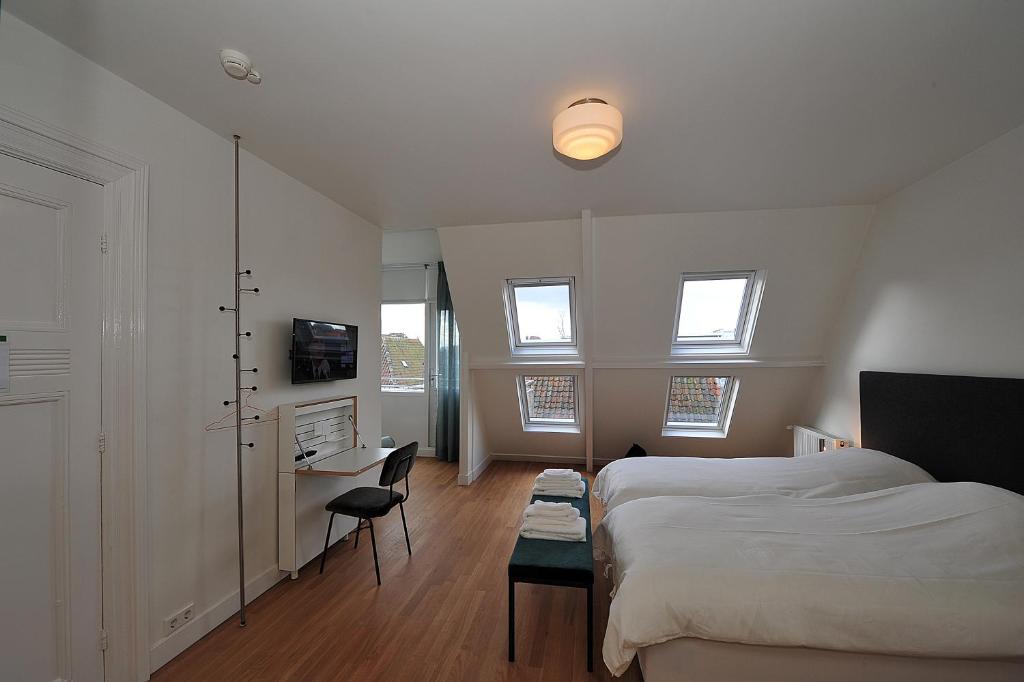 Een bed of bedden in een kamer bij Boetiek Hotel Kampen