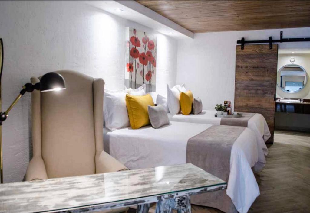 Postel nebo postele na pokoji v ubytování NEhotel Nueva Estancia