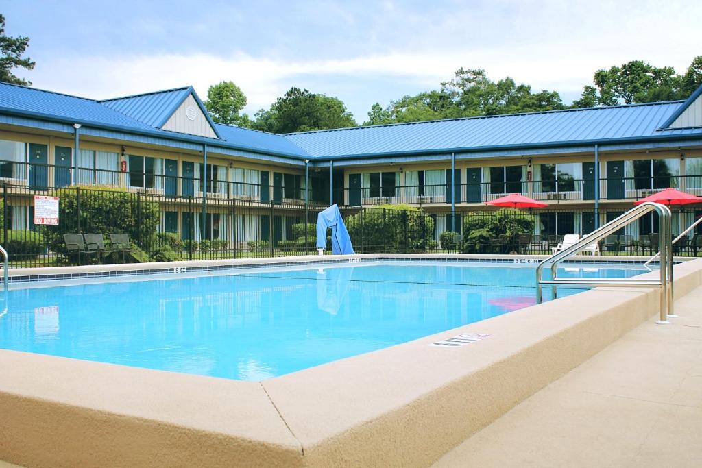 a swimming pool in front of a hotel at Residence Hub Inn and Suites in Marianna