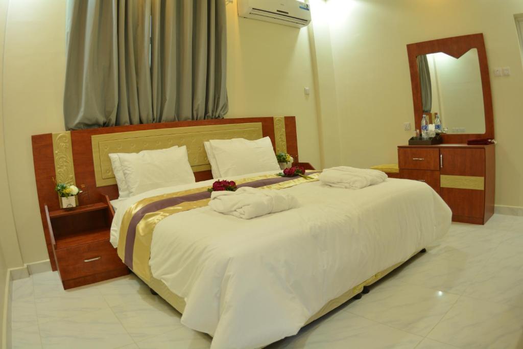 Postel nebo postele na pokoji v ubytování Bahla Jewel Hotel Apartments