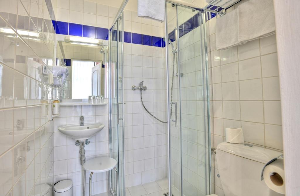 a bathroom with a shower and a sink and a toilet at Máchova in Prague