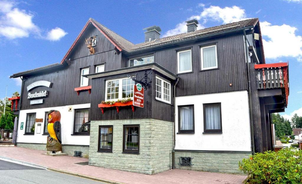 ein schwarzweißes Gebäude mit einer Statue davor in der Unterkunft Landhaus Brockenblick in Hohegeiß