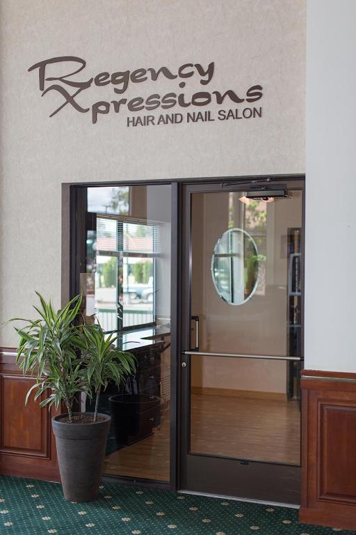 a sign that reads recovery preparing hair and nail salon at Rogue Regency Inn & Suites in Medford