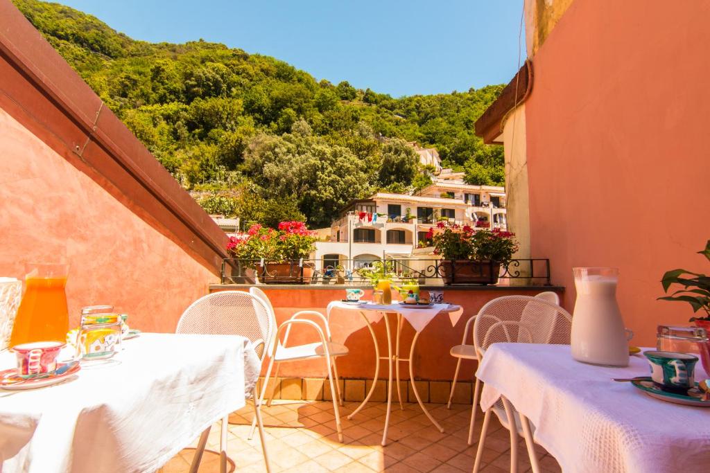 a balcony with tables and chairs with a view at B&B Sotto un Tetto in Cetara