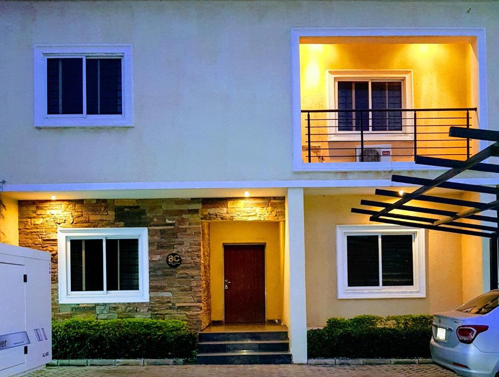 a house with a staircase in front of it at Nicotel Apartments in Abuja