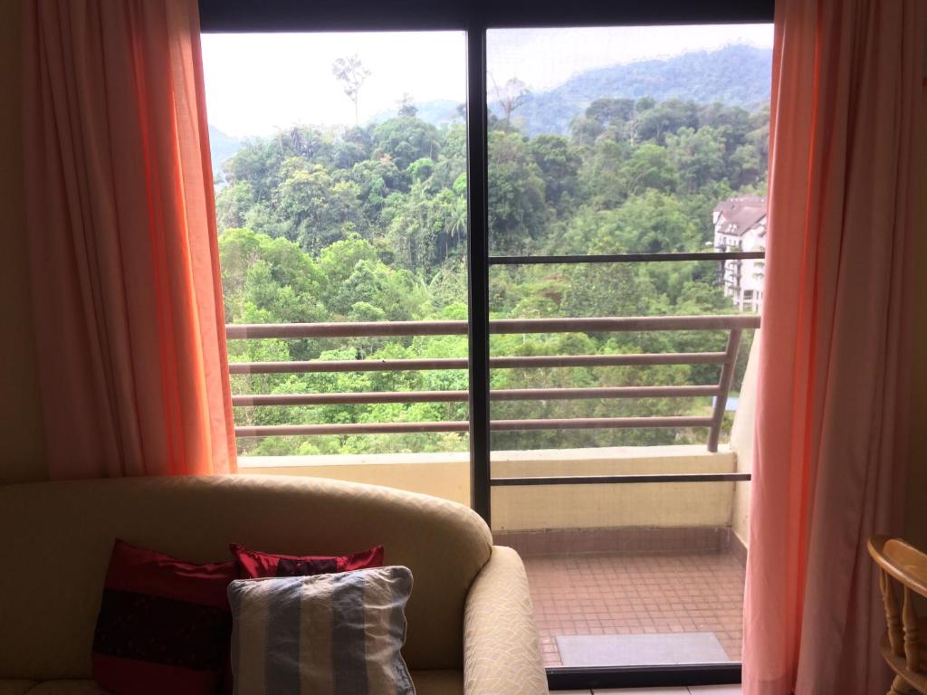 a room with a couch and a large window at 2 bed Kempas D2-705 Genting Highland in Genting Highlands