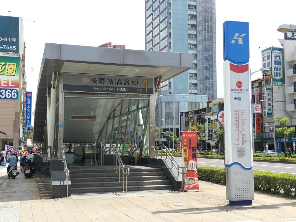 a bus stop in a city with stairs and buildings at Knock Knock Hostel in Kaohsiung