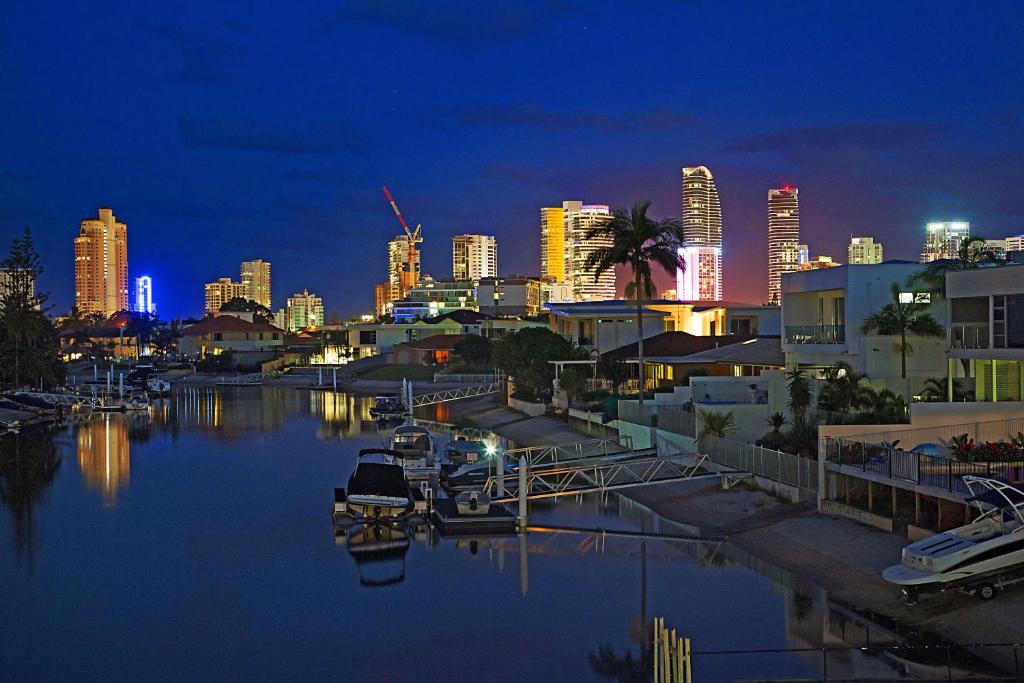 a city skyline at night with a marina with boats at C'est La Vie in Gold Coast