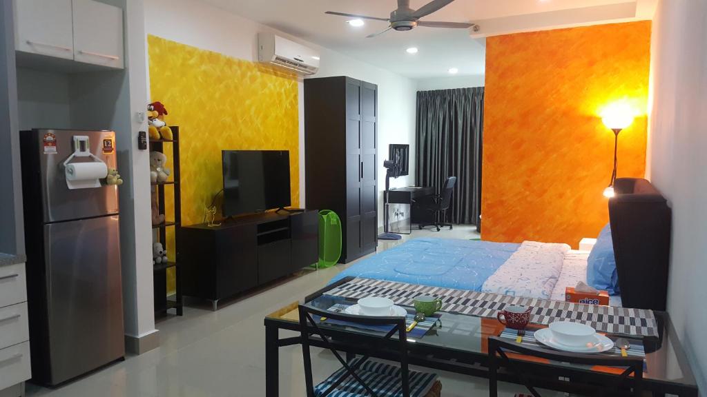 a living room with a kitchen and a room with a refrigerator at Residence @ Shaftsbury Cyberjaya in Cyberjaya