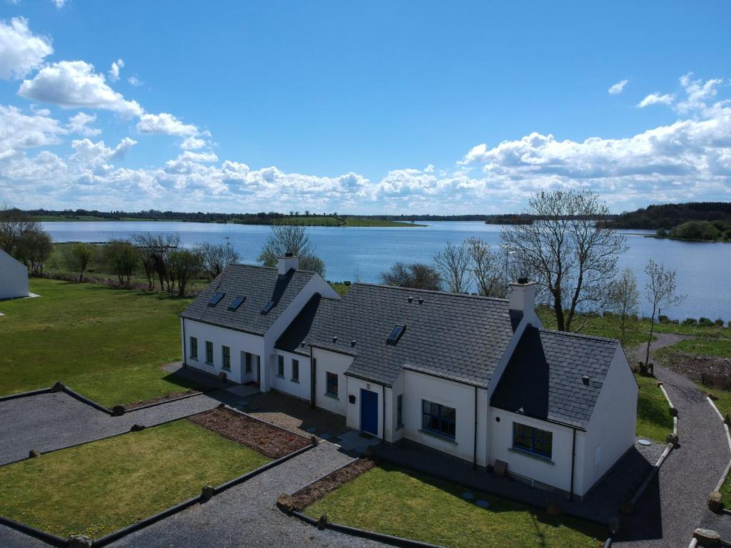 an aerial view of a house with a lake at Erne View Cottages in Lisnaskea